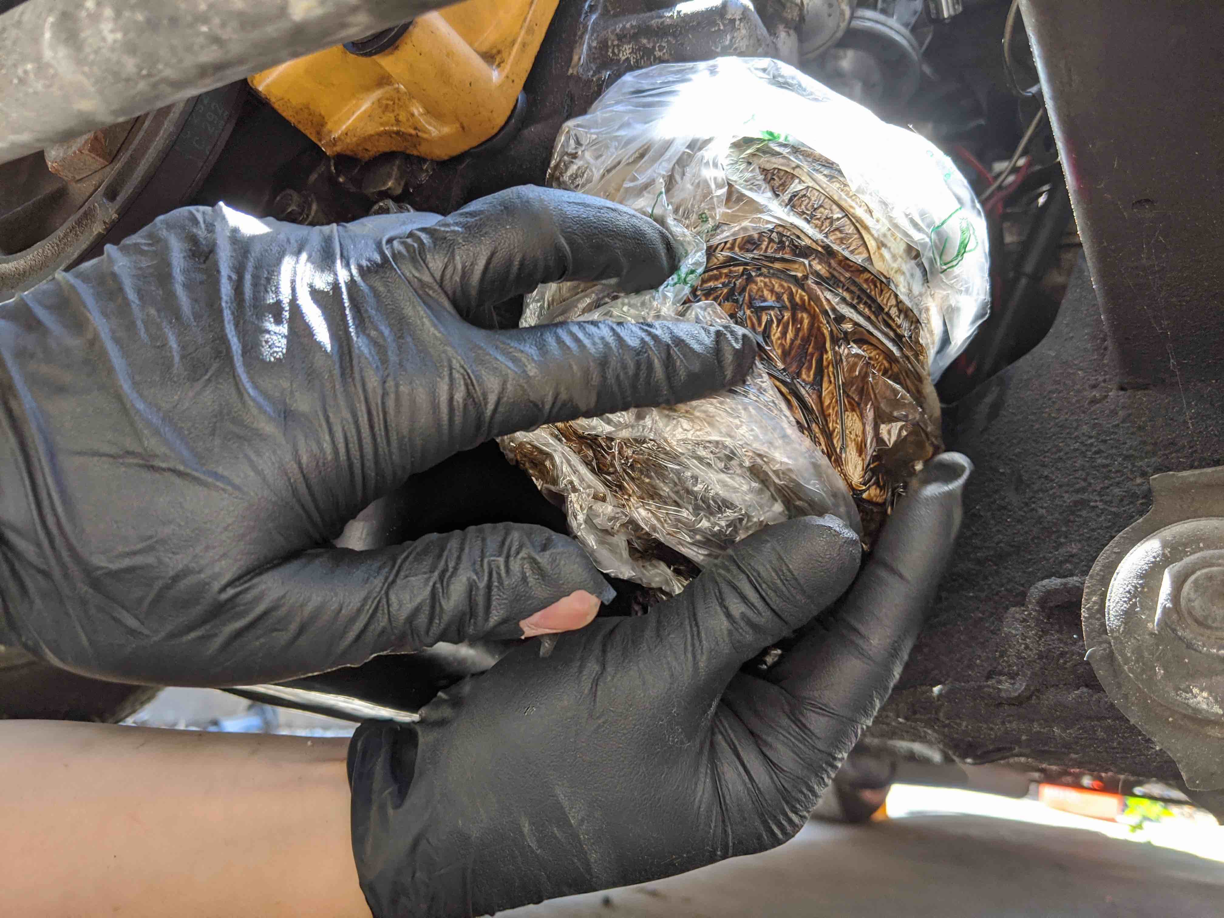 Using a bag to catch oil